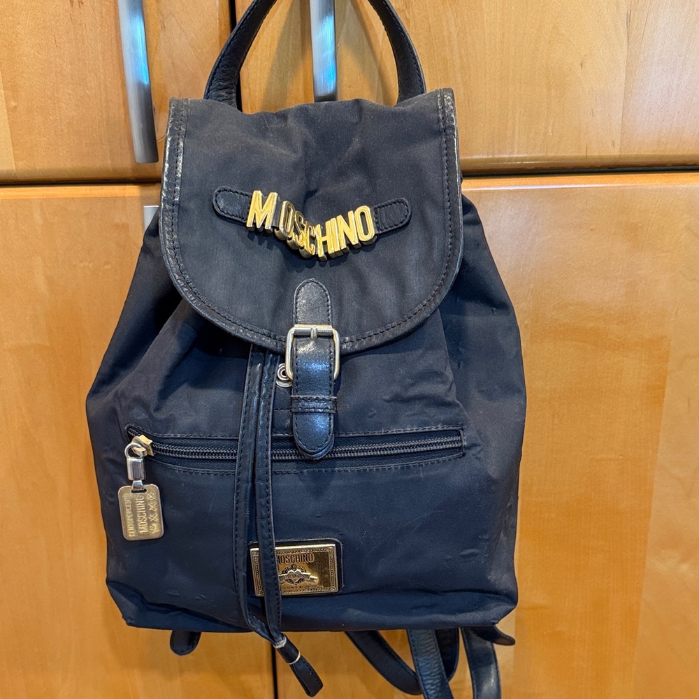 AUTHENTIC Moschino Black Nylon Logo Drawstring Backpack with Gold Hardware